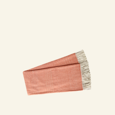 The Brick Woven Throw laying on a beige background.