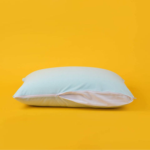 The zipper opened halfway on the Slumber Cloud Adjustable UltraCool Pillow on a cream background