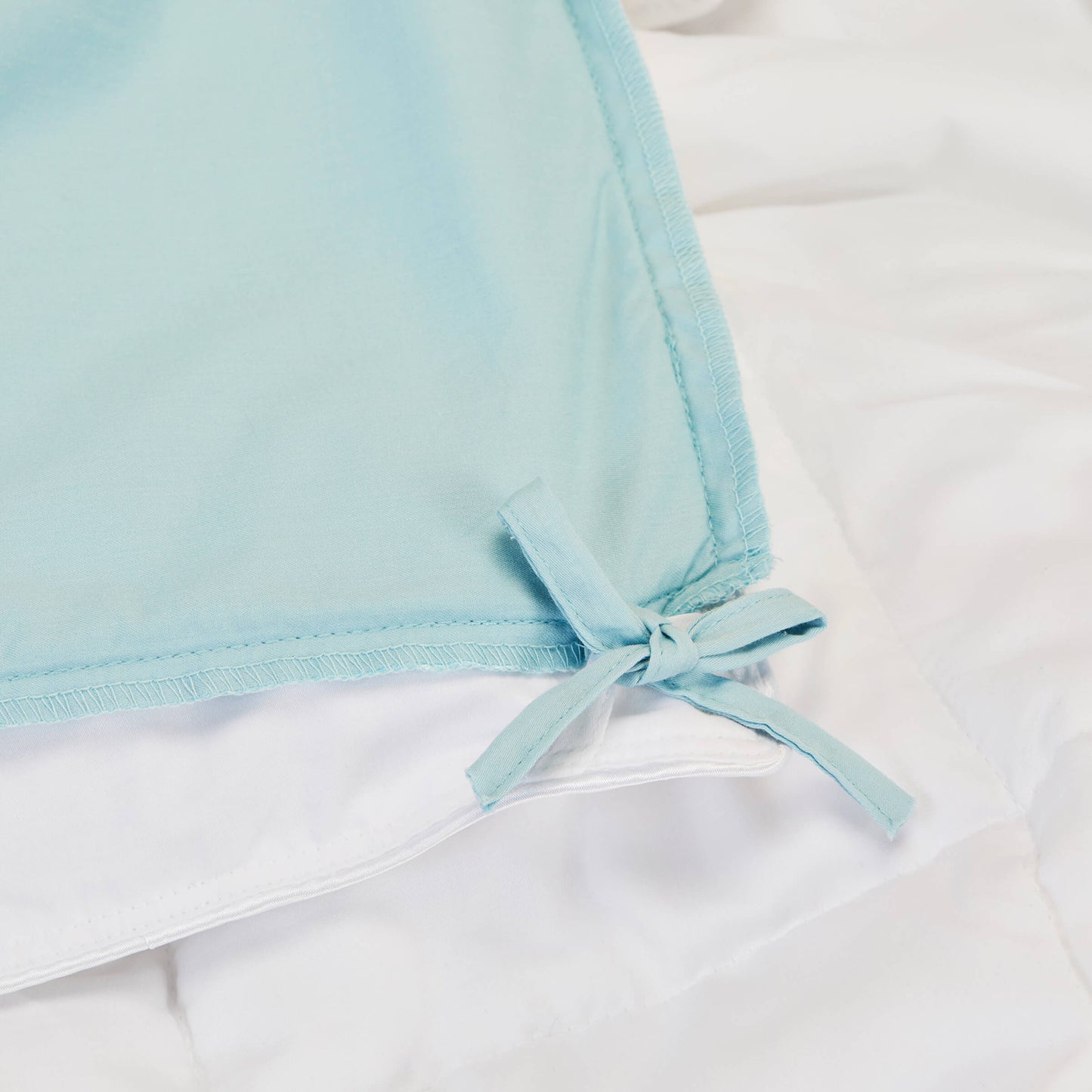 Detailed view of the corner loops on the Slumber Cloud Lightweight Comforter made with Outlast temperature regulation technology to help you stay cool through the night. | Cooling Technology