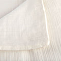 A detailed view of the fabric on the Avec lightweight cotton quilt in pearl