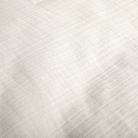 A detailed view of the fabric on the Avec cotton quilt in pearl