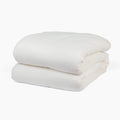 Avec cotton quilt in pearl folded neatly on a white background