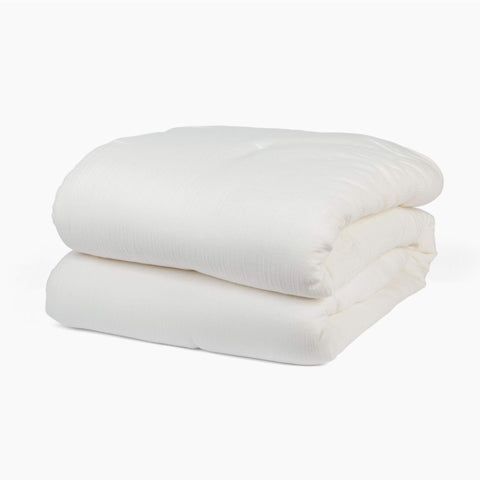 Avec cotton quilt in pearl folded neatly on a white background