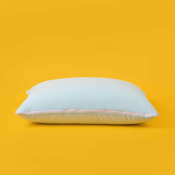 The Slumber Cloud Adjustable UltraCool Pillow on a cream background