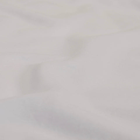 A detailed view of the fabric of the Slumber Cloud Essential Fitted Sheet - Crib