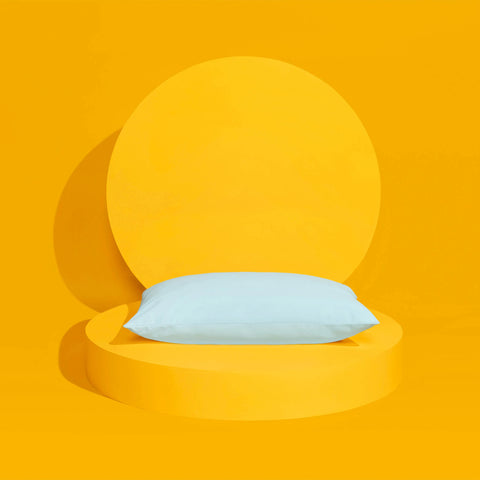 A Slumber Cloud UltraCool Pillow on a yellow background