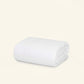 The Slumber Cloud Comforter made with temperature regulation technology on a cream background