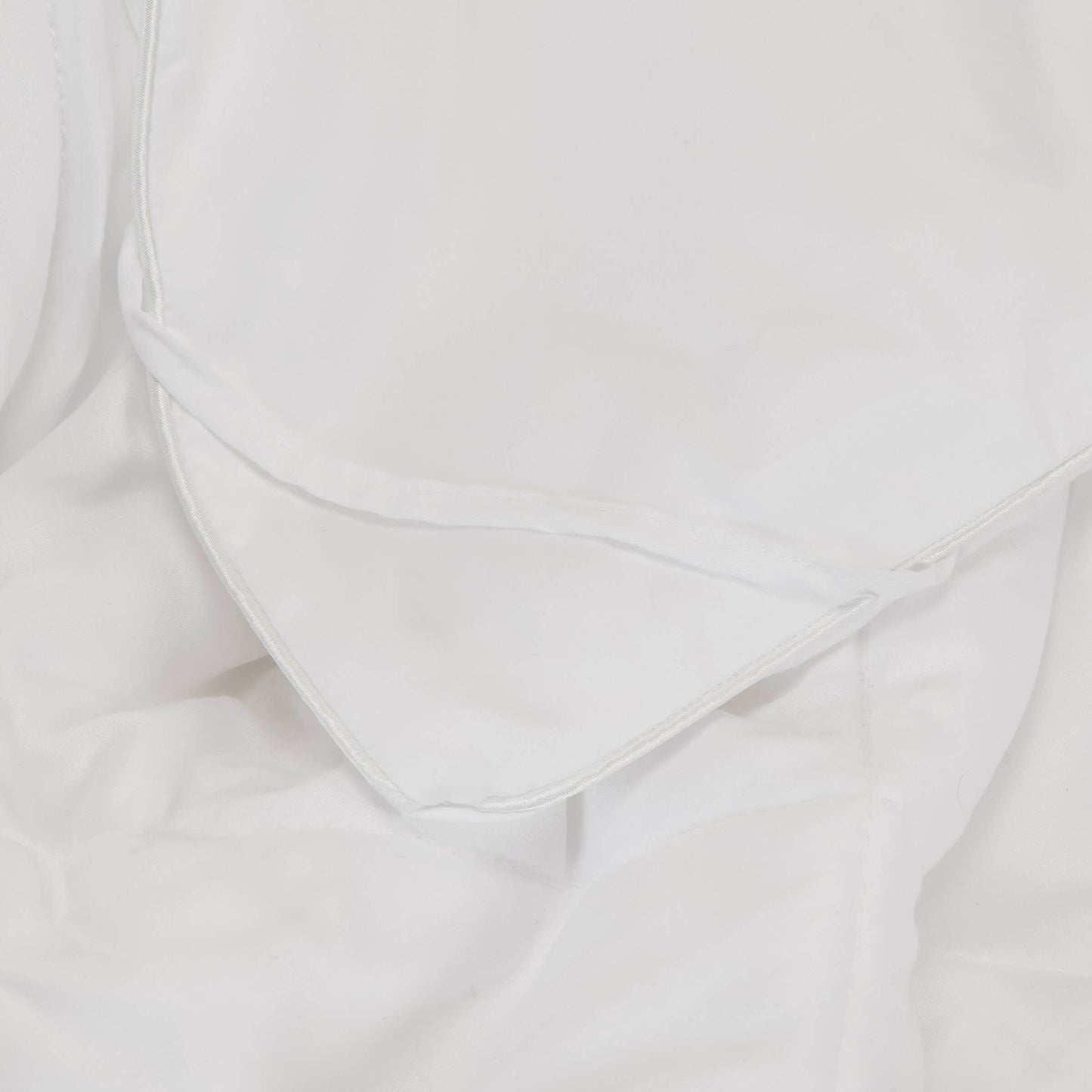 A detailed close up of the Slumber Cloud Comforter showing the corner loops