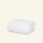 The Slumber Cloud Comforter made with temperature regulation technology on a cream background