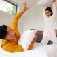 A couple pillow fighting with Slumber Cloud Core Down Alternative Pillow