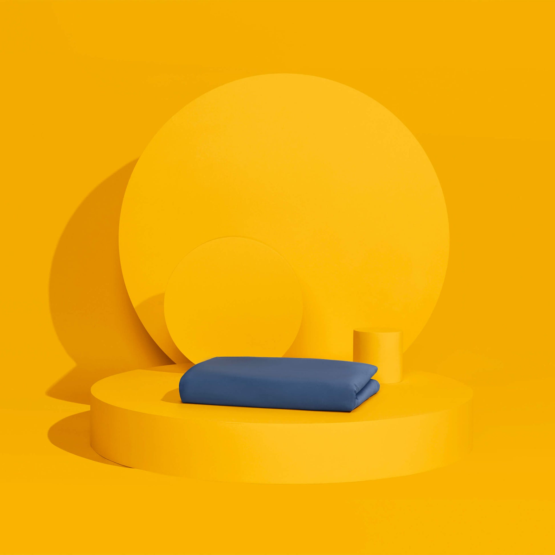 The Slumber Cloud Essential Duvet Cover with temperature regulation technology folded and propped on a yellow background