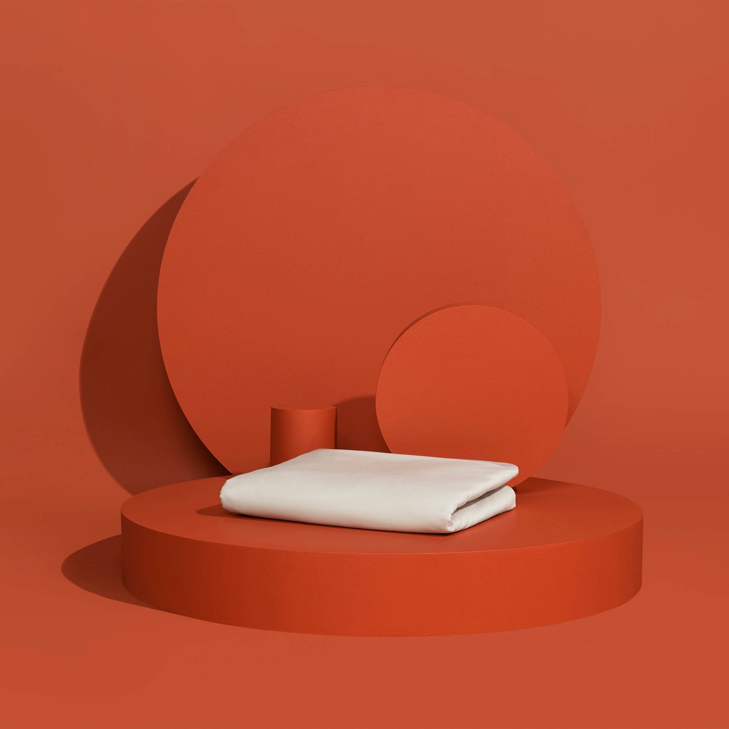 The Slumber Cloud Essential Duvet Cover with temperature regulation technology folded and propped on a red background