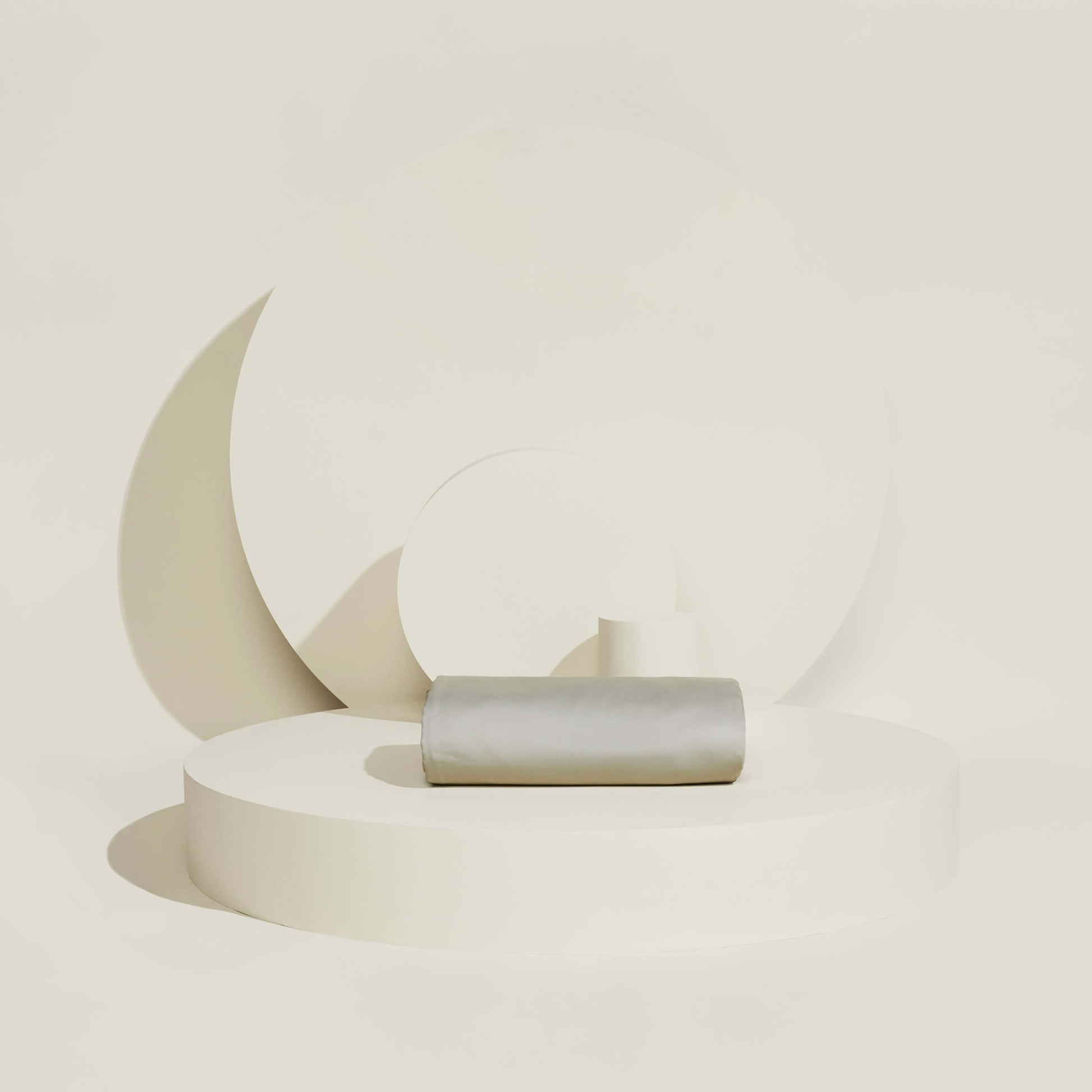 The Slumber Cloud Essential Duvet Cover with temperature regulation technology folded and propped on a creambackground