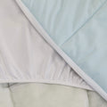 A close up shot of the Slumber Cloud Essential Mattress Pad made with Outlast temperature regulation technology.