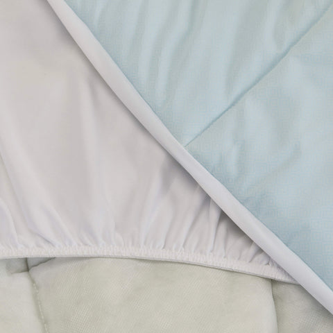 A close up shot of the Slumber Cloud Essential Mattress Pad made with Outlast temperature regulation technology.