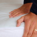 A close up shot of the Slumber Cloud Essential Mattress Pad made with Outlast temperature regulation technology.