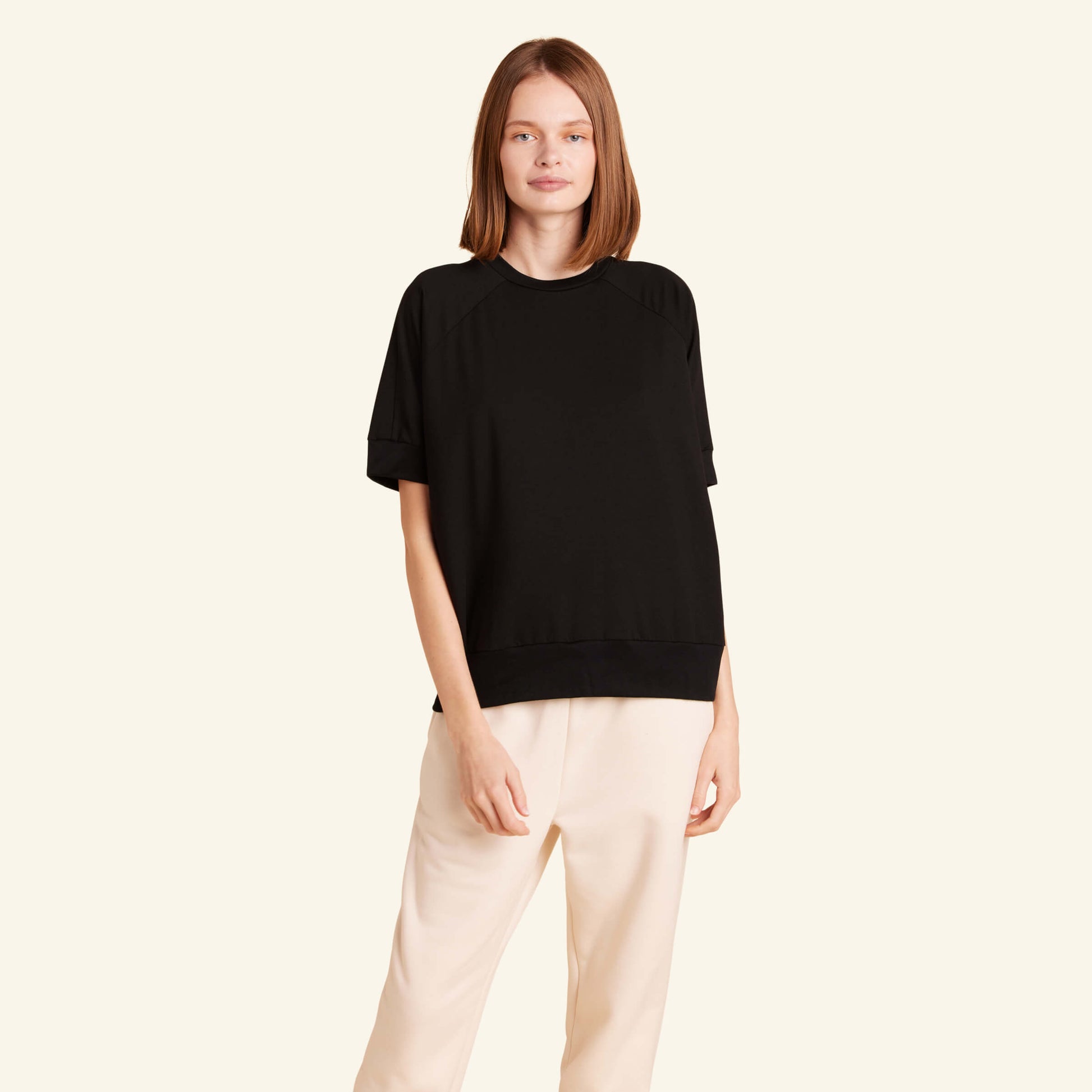 Woman wearing the Slumber Cloud Essential Raglan Pullover made with Outlast temperature regulation technology