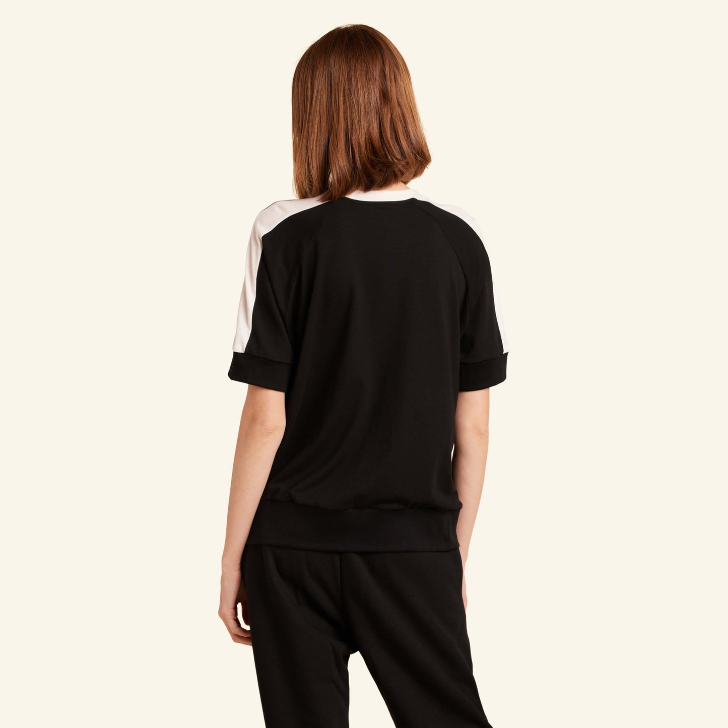 Woman wearing the Slumber Cloud Essential Raglan Pullover made with Outlast temperature regulation technology