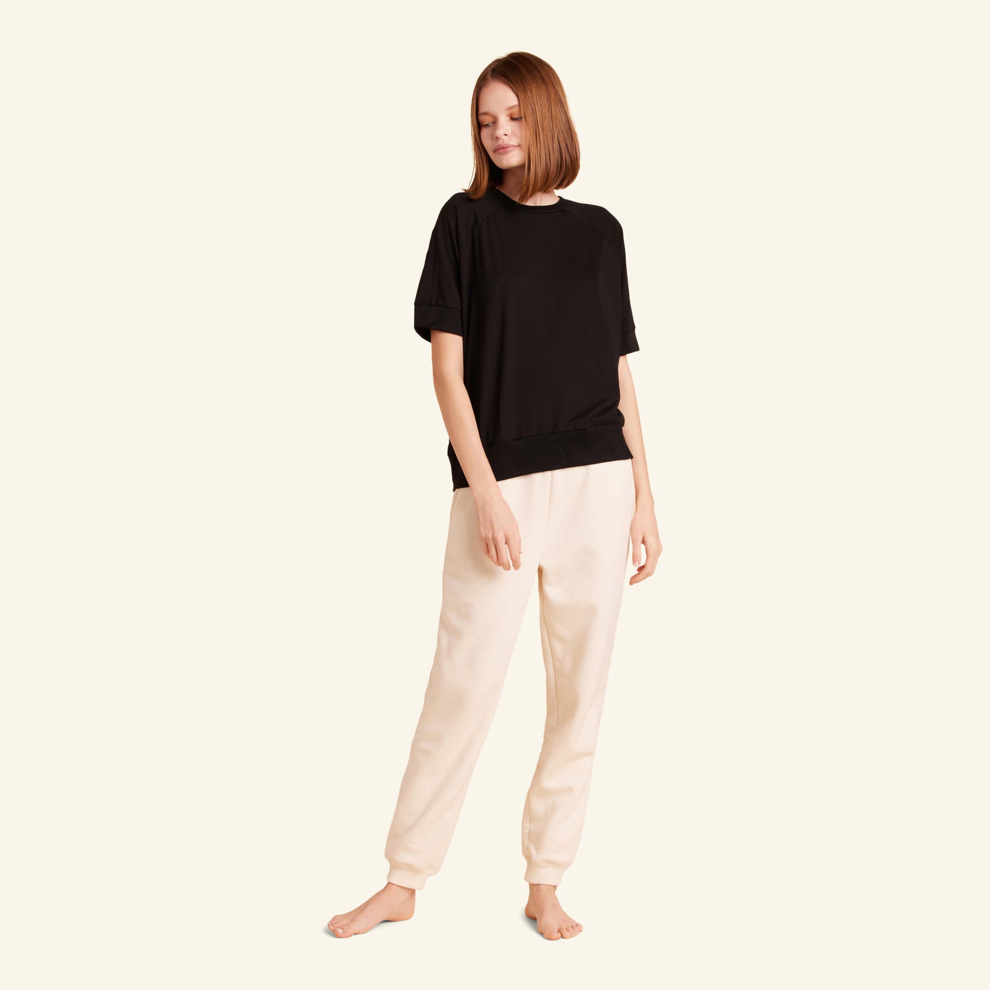 Woman wearing the Slumber Cloud Essential Raglan Pullover made with Outlast temperature regulation technology