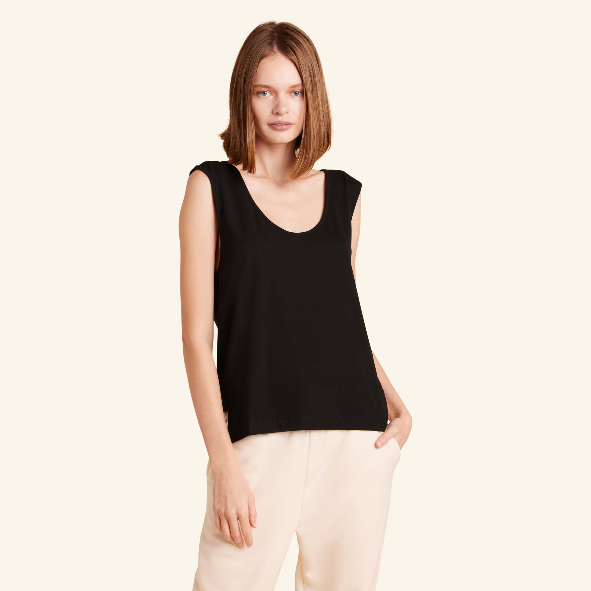 Woman wearing the Slumber Cloud Essential Tank made with Outlast temperature regulation technology