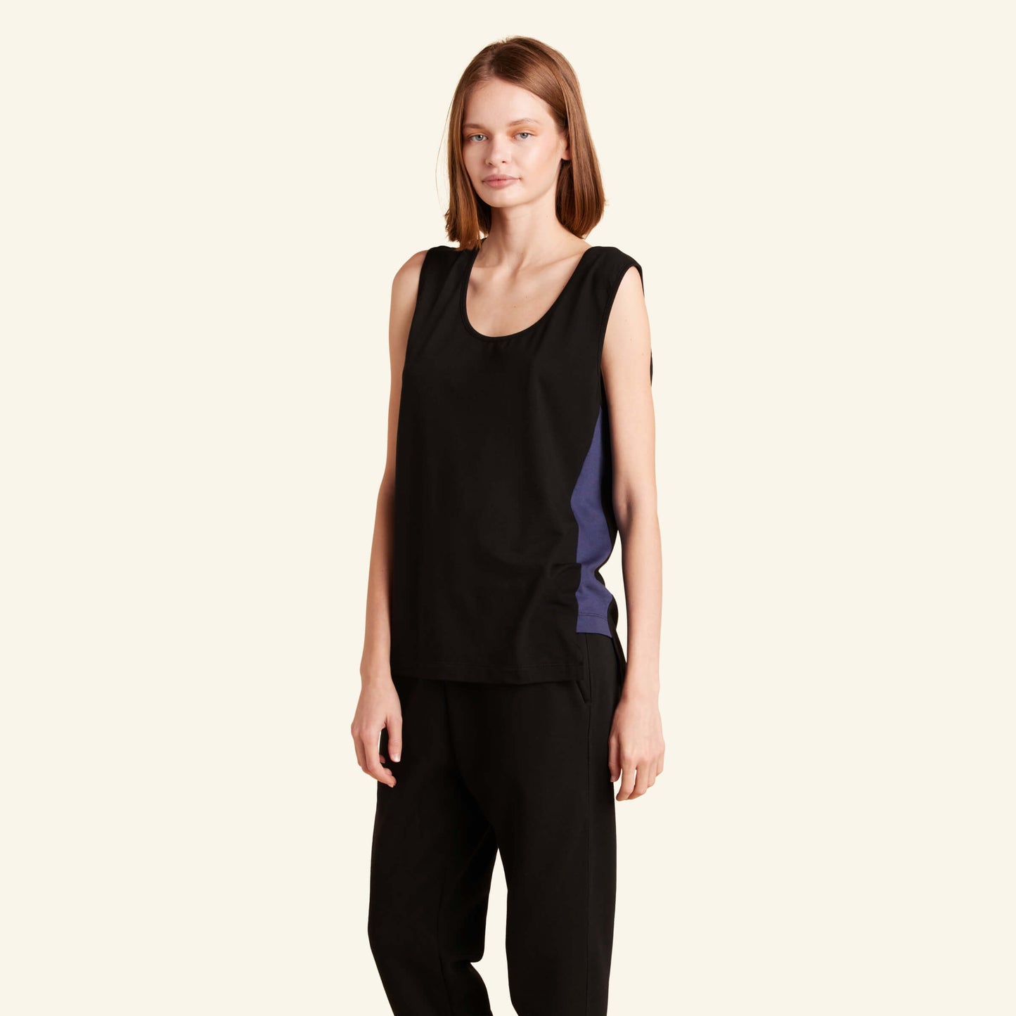 Woman wearing the Slumber Cloud Essential Tank made with Outlast temperature regulation technology