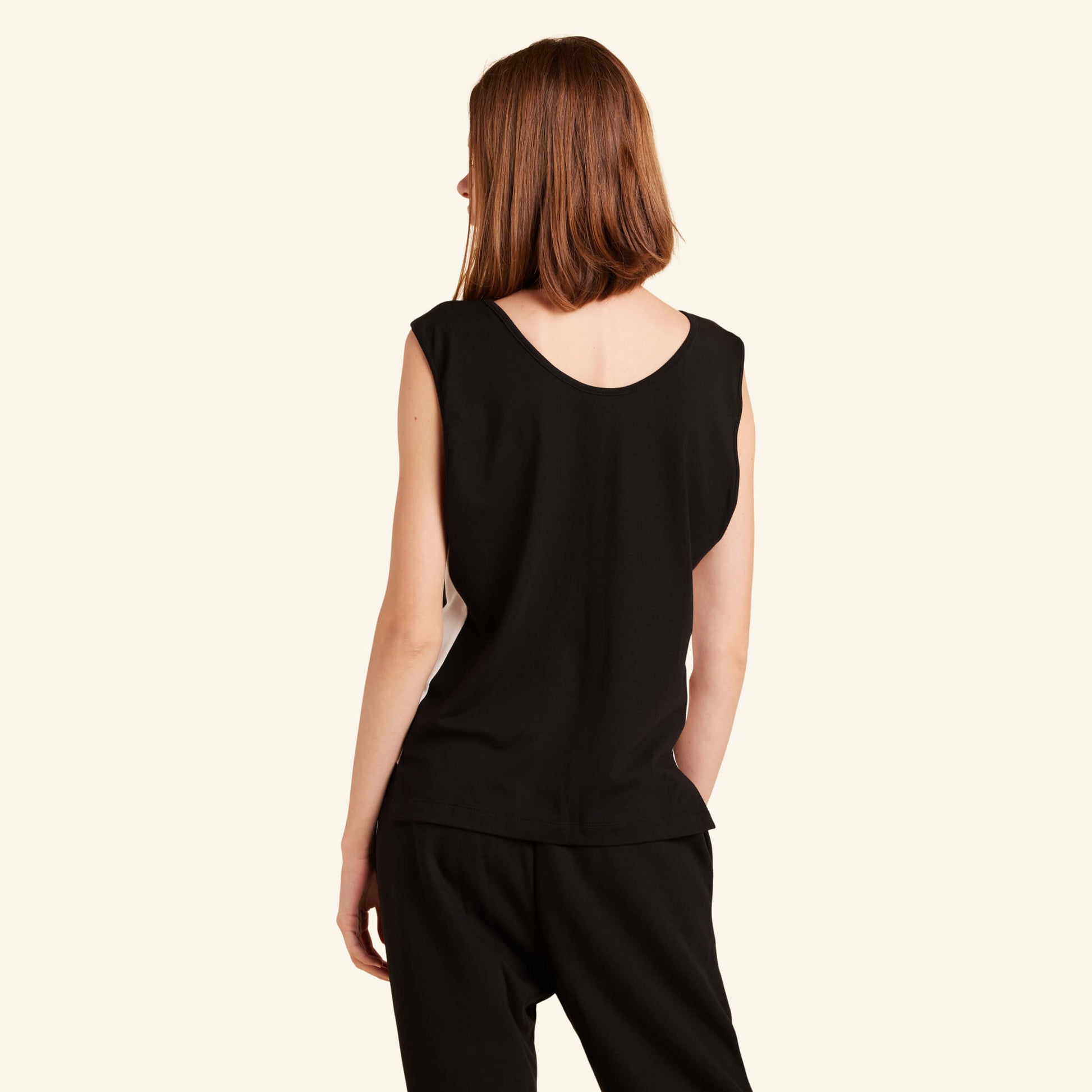 Woman wearing the Slumber Cloud Essential Tank made with Outlast temperature regulation technology