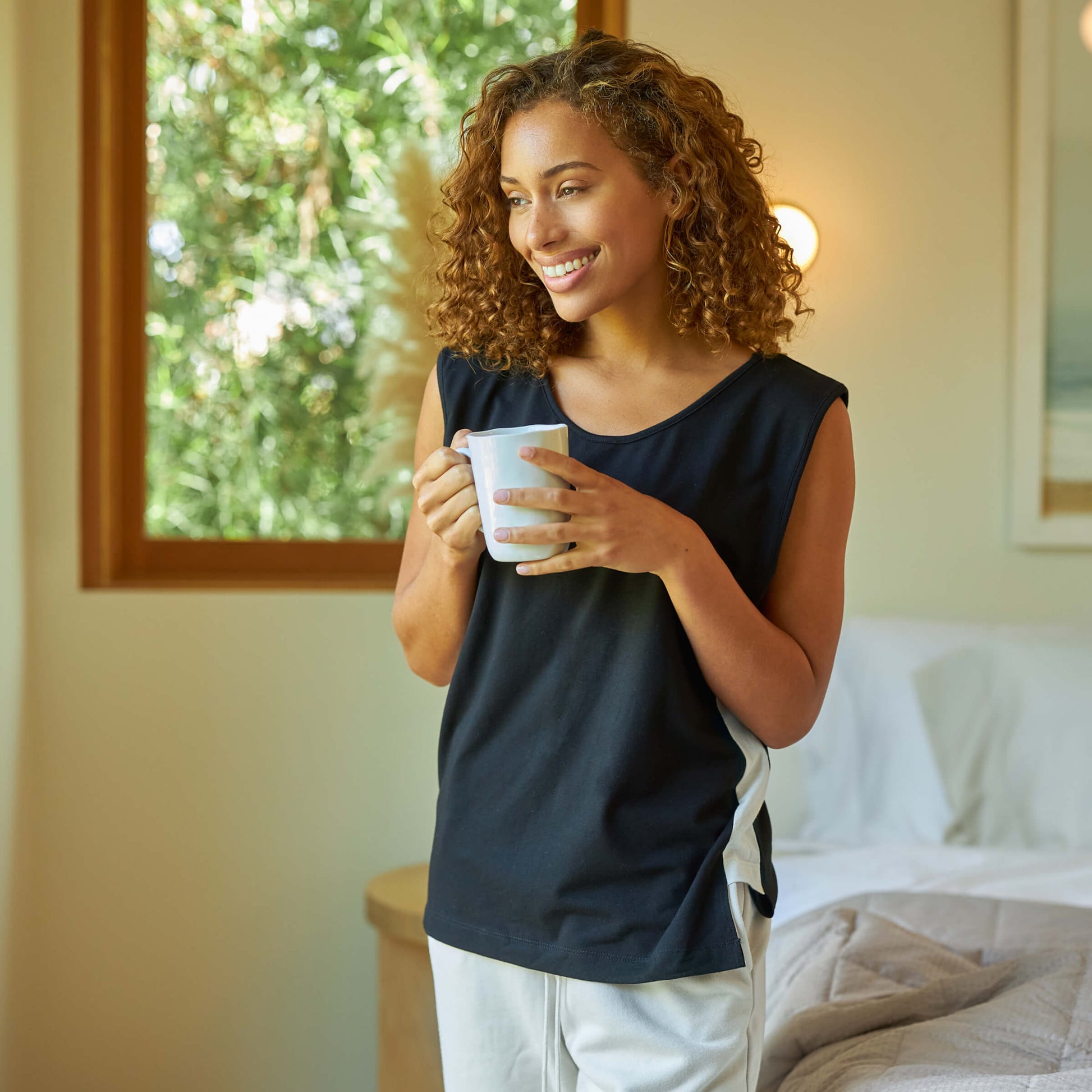 Woman wearing the Slumber Cloud Essential Tank made with Outlast temperature regulation technology