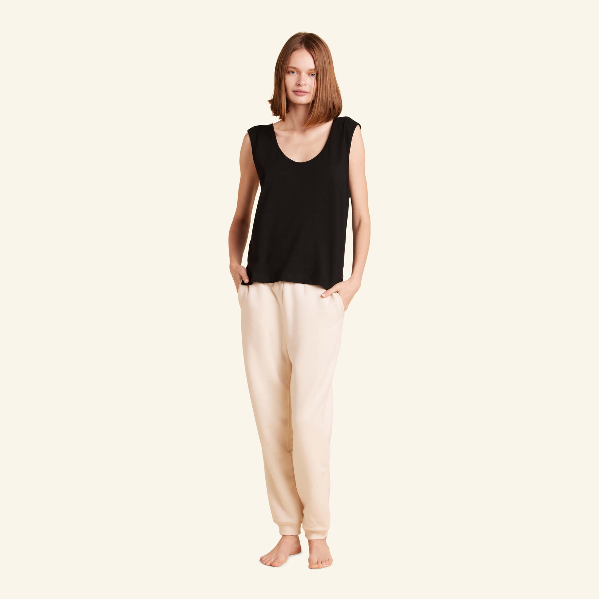 Woman wearing the Slumber Cloud Essential Tank made with Outlast temperature regulation technology