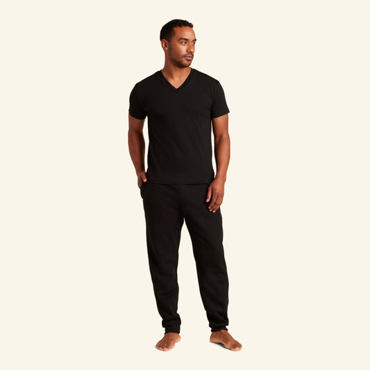 Man wearing the Slumber Cloud Essential V-Neck made with Outlast® temperature regulation technology to help keep you cool and comfortable throughout the night
