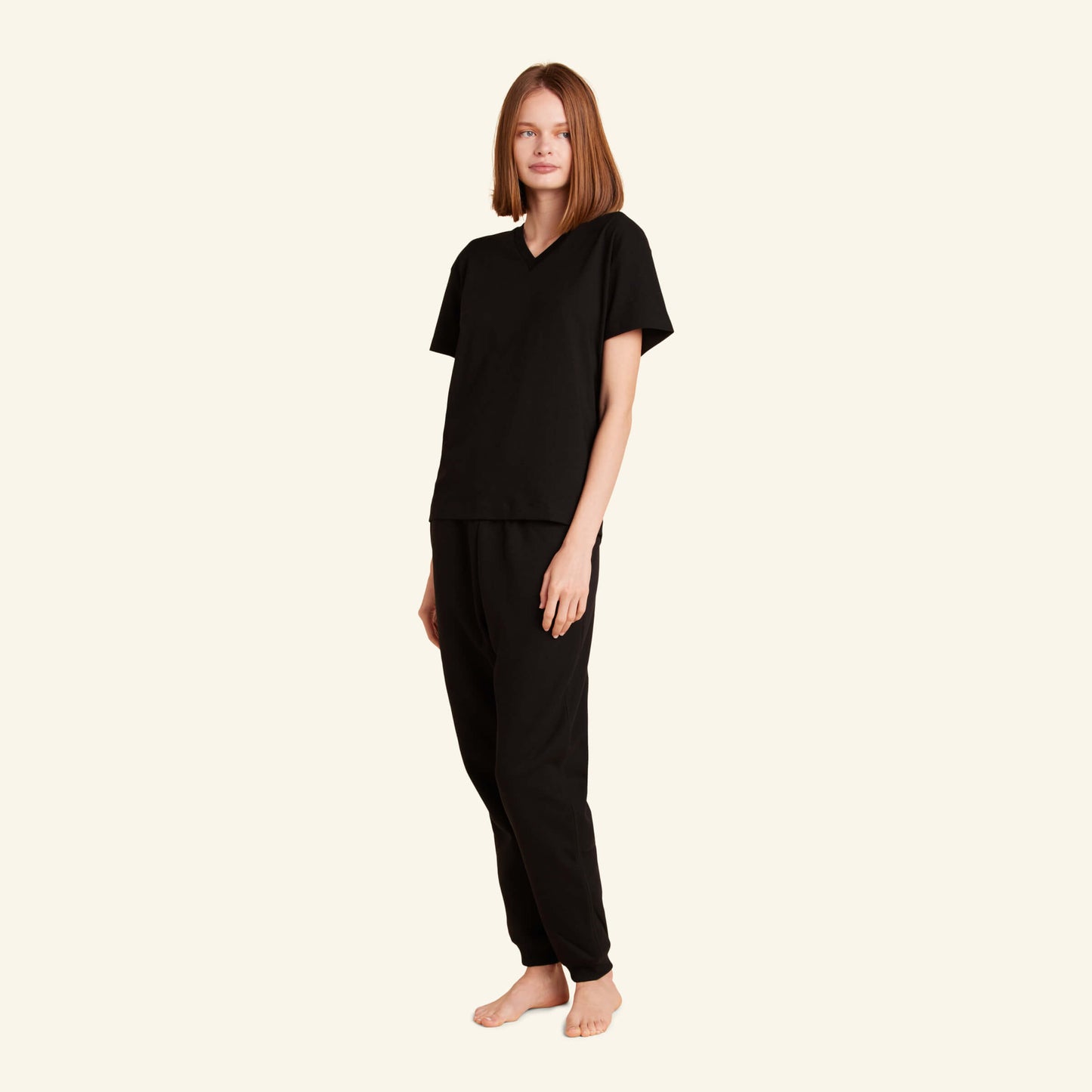 Woman wearing the Slumber Cloud Essential V-Neck made with Outlast® temperature regulation technology to help keep you cool and comfortable throughout the night