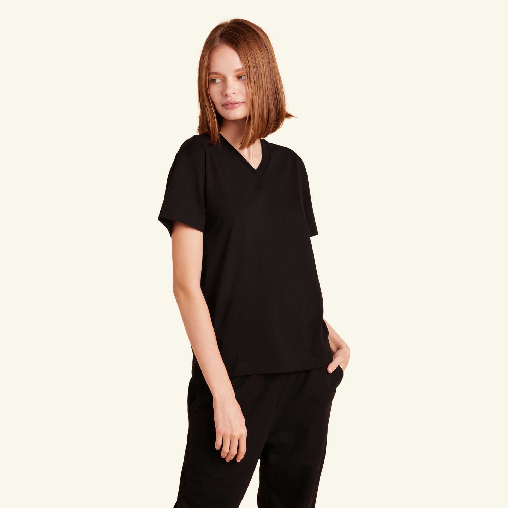 Woman wearing the Slumber Cloud Essential V-Neck made with Outlast temperature regulation technology