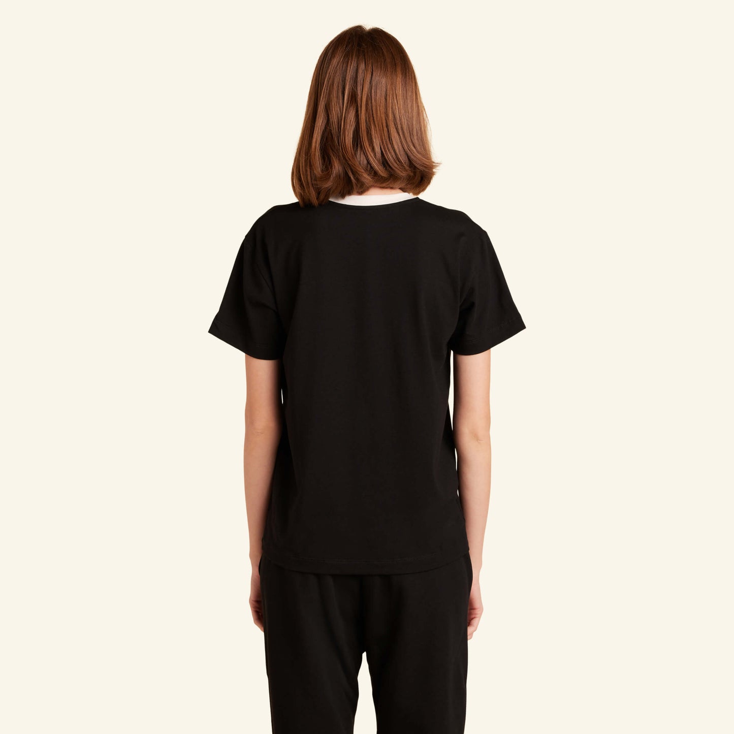 Woman wearing the Slumber Cloud Essential V-Neck made with Outlast temperature regulation technology
