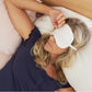 A woman wearing the Slumber Cloud 100% Silk Sleep Mask made with Outlast temperature regulation technology