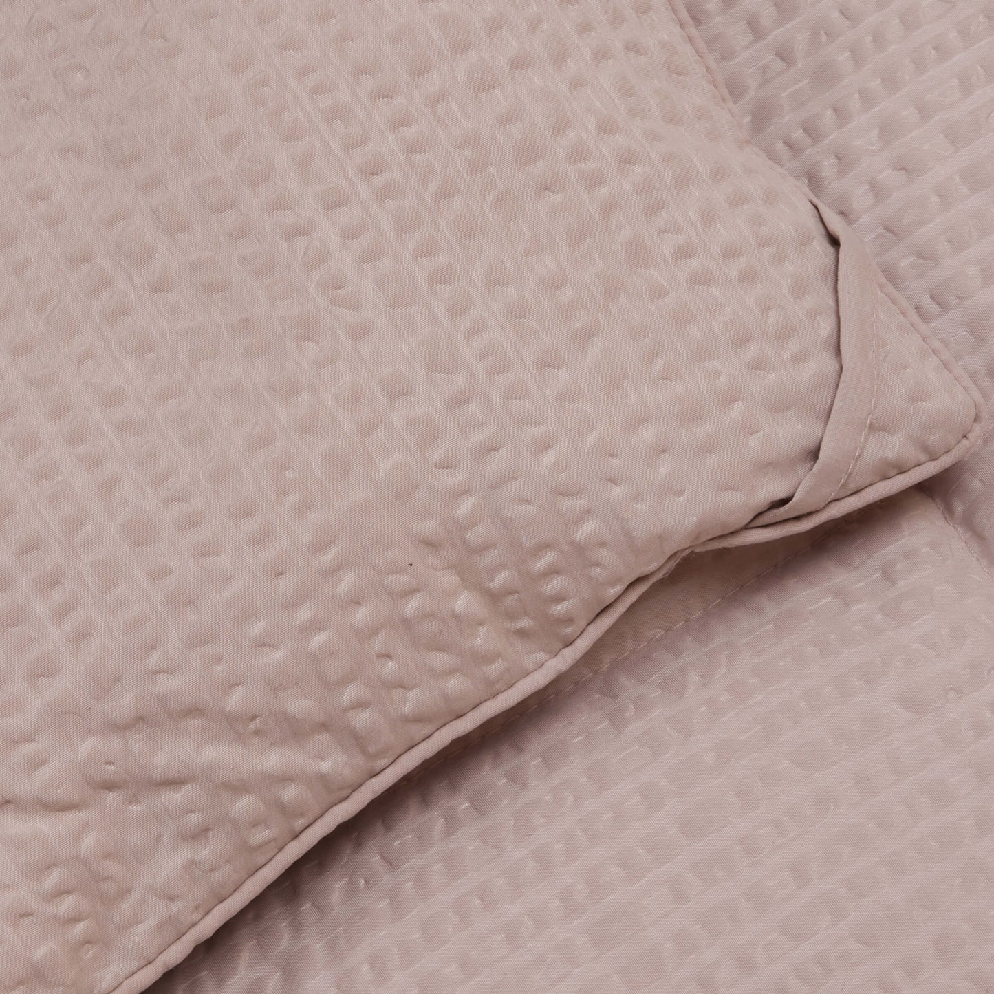 Detailed view of the corner loops on the Slumber Cloud Textured Blanket in oat made with Outlast Temperature Regulation Technology