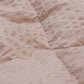 Detailed view of the Slumber Cloud Textured Blanket in oat made with Outlast Temperature Regulation Technology